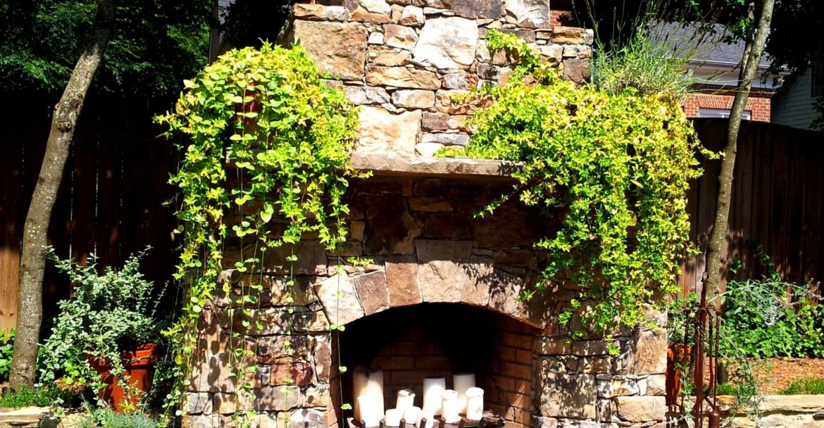 Installation of outdoor stone fireplace design in Charlotte, NC by Charlotte Pavers & Stone.