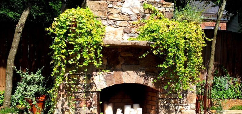 Installation of outdoor stone fireplace design in Charlotte, NC by Charlotte Pavers & Stone.